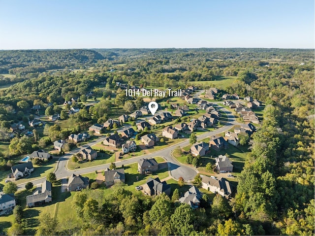 birds eye view of property with a view of trees and a residential view