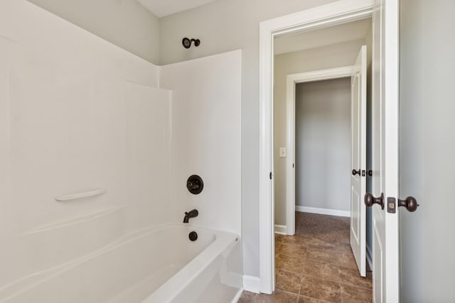 bathroom with shower / bathtub combination and baseboards
