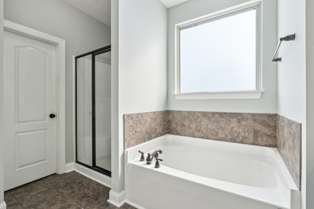 full bath with a garden tub and a stall shower