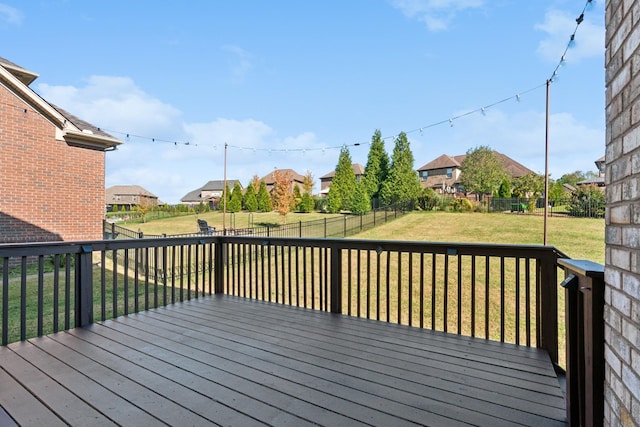 wooden deck with a lawn, a fenced backyard, and a residential view