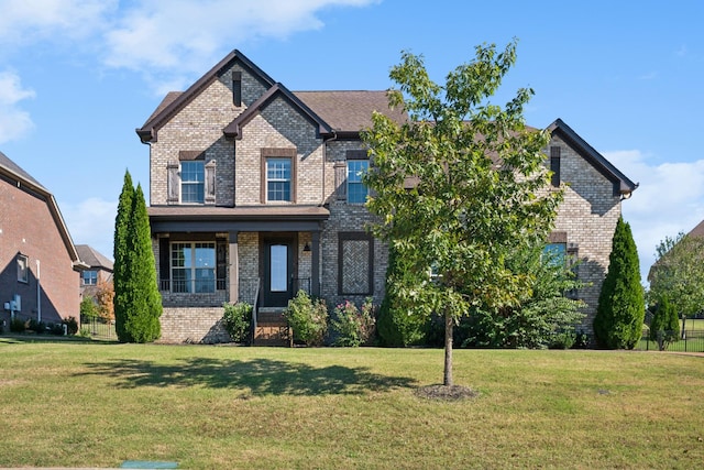 craftsman inspired home featuring brick siding and a front lawn