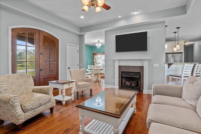 living room with hardwood / wood-style floors, a wealth of natural light, and ceiling fan