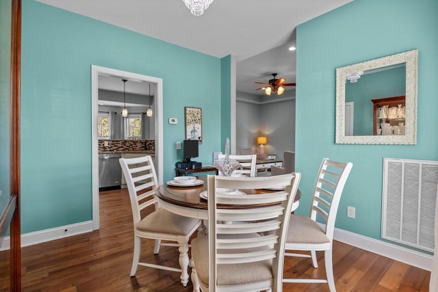 dining space featuring ceiling fan, wood finished floors, and visible vents