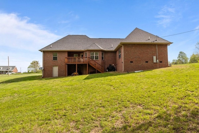 rear view of house with a wooden deck, a lawn, and stairs