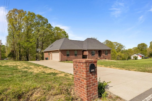 single story home featuring brick siding, a front lawn, driveway, and a garage