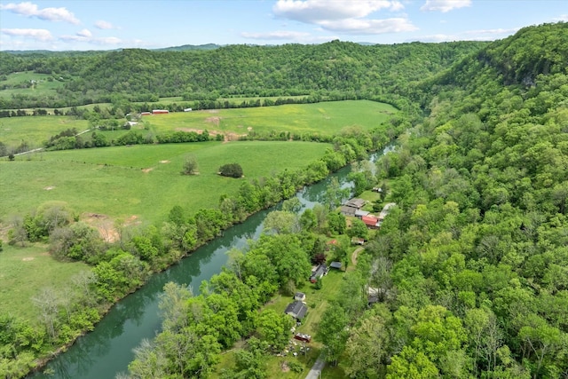 aerial view with a wooded view and a water view