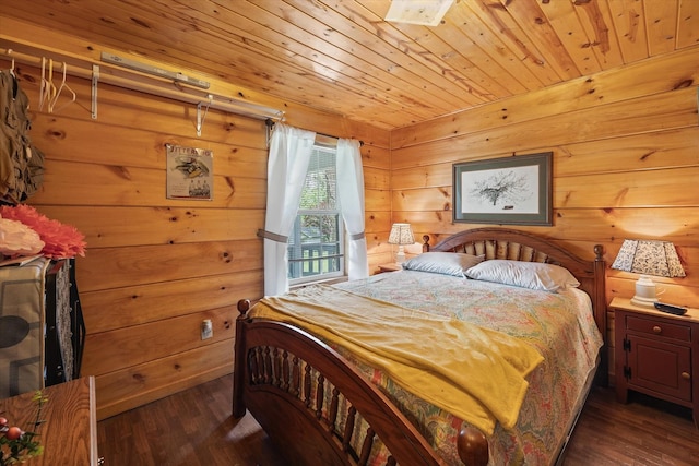 bedroom with wood walls, wooden ceiling, and dark wood-style flooring