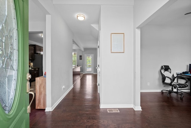 entryway featuring baseboards, wood finished floors, and visible vents