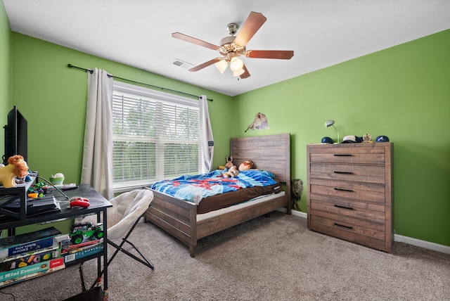 carpeted bedroom with ceiling fan, baseboards, and visible vents