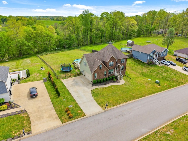 birds eye view of property with a view of trees