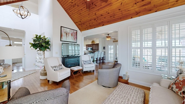 1100 Cypress Rd, Buchanan, TN 38222 - living room with high vaulted ceiling, baseboards, wood finished floors, and ceiling fan with notable chandelier