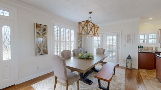 1100 Cypress Rd, Buchanan, TN 38222 - dining room with light wood-style flooring, crown molding, and baseboards