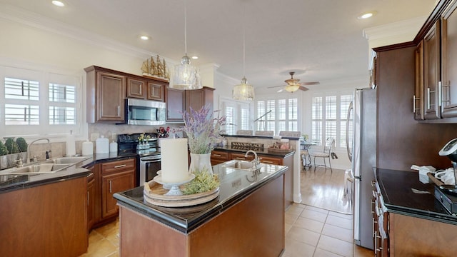 1100 Cypress Rd, Buchanan, TN 38222 - kitchen featuring a ceiling fan, stainless steel appliances, a kitchen island with sink, and a sink