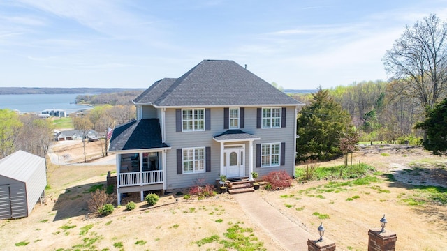 1100 Cypress Rd, Buchanan, TN 38222 - colonial-style house featuring a shingled roof and a water view