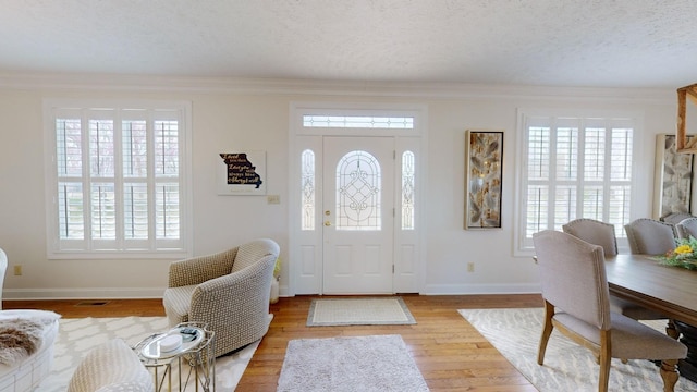 1100 Cypress Rd, Buchanan, TN 38222 - entrance foyer with wood finished floors, a textured ceiling, baseboards, ornamental molding, and visible vents