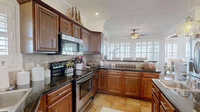 1100 Cypress Rd, Buchanan, TN 38222 - kitchen with ceiling fan, a wealth of natural light, decorative backsplash, and stainless steel appliances