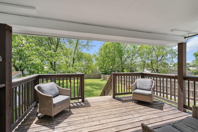 deck with a lawn and a fenced backyard