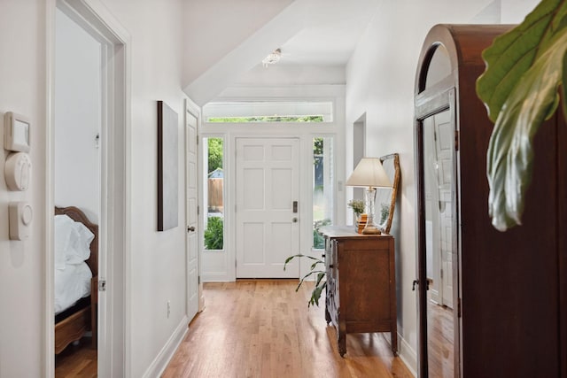foyer with light wood-type flooring and baseboards