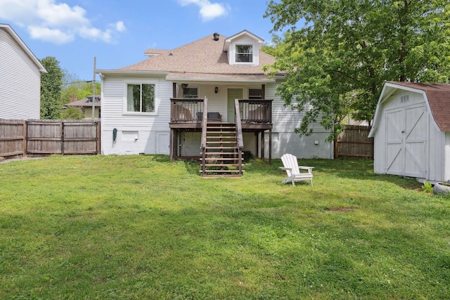 back of property featuring stairway, a fenced backyard, a shed, and a deck