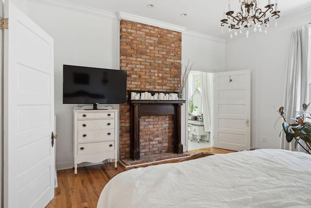 bedroom with wood finished floors, an inviting chandelier, and crown molding