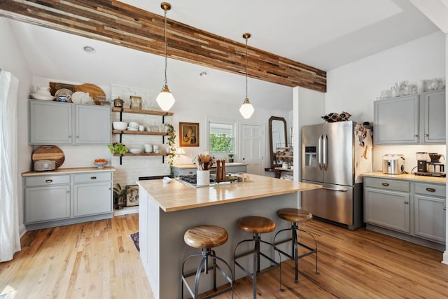 kitchen featuring gray cabinets, gas cooktop, light wood-style floors, wood counters, and stainless steel refrigerator with ice dispenser