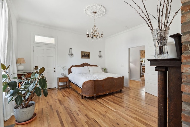 bedroom with light wood-style flooring, baseboards, an inviting chandelier, and crown molding