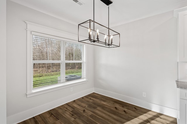 unfurnished dining area with a chandelier, visible vents, dark wood-style flooring, and baseboards