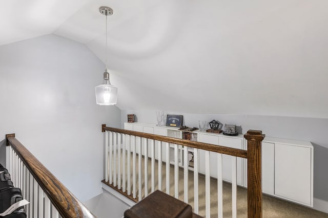 staircase with lofted ceiling and carpet flooring