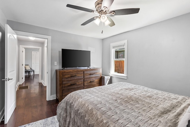 bedroom featuring dark wood finished floors, baseboards, a ceiling fan, and visible vents