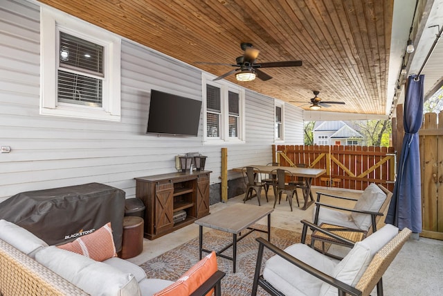 view of patio with fence, a ceiling fan, outdoor lounge area, and outdoor dining space