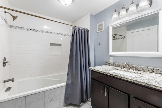 full bath featuring tiled shower / bath combo, visible vents, and vanity