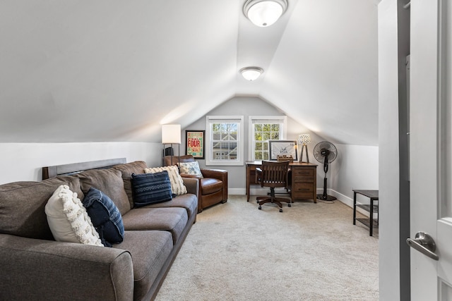 carpeted office space with lofted ceiling and baseboards