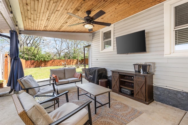 view of patio / terrace featuring an outdoor living space, ceiling fan, a fenced backyard, and grilling area