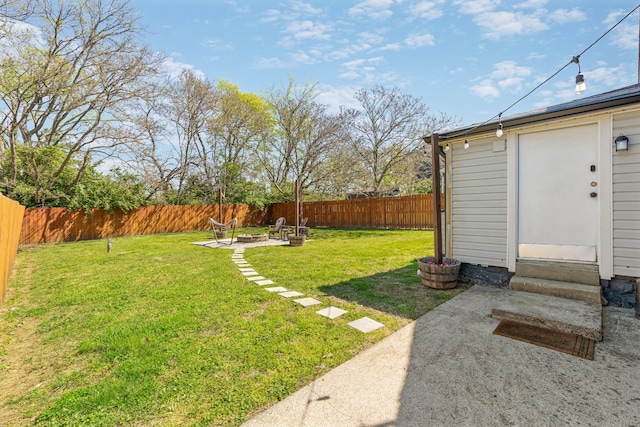 view of yard featuring a fire pit, entry steps, a fenced backyard, and a patio