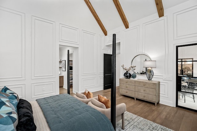 7247 Murrel Dr, Franklin, TN 37064 - bedroom featuring beam ceiling, dark wood-type flooring, high vaulted ceiling, and a decorative wall