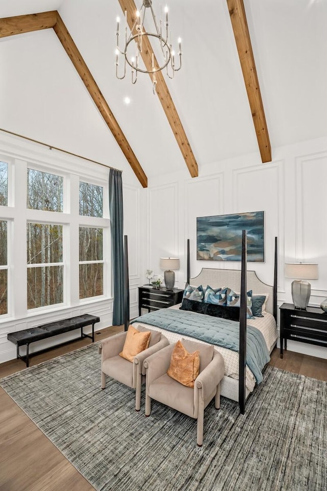 7247 Murrel Dr, Franklin, TN 37064 - bedroom featuring high vaulted ceiling, a decorative wall, wood finished floors, a notable chandelier, and beam ceiling