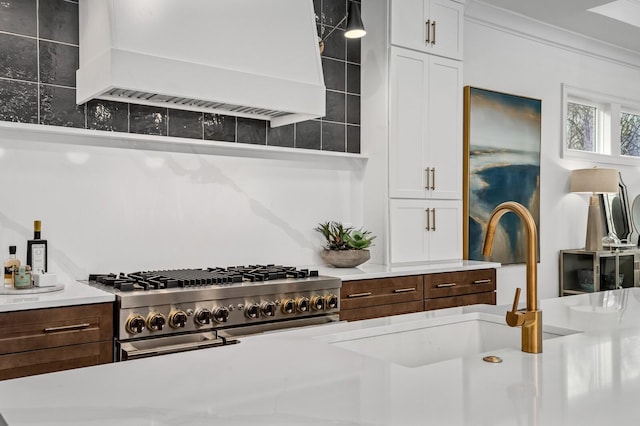 7247 Murrel Dr, Franklin, TN 37064 - kitchen with custom exhaust hood, tasteful backsplash, light countertops, range with two ovens, and white cabinetry
