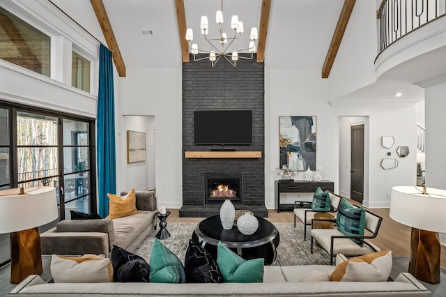 7247 Murrel Dr, Franklin, TN 37064 - living area featuring a towering ceiling, wood finished floors, beamed ceiling, a fireplace, and a notable chandelier