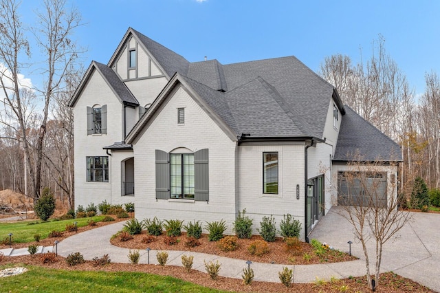 7247 Murrel Dr, Franklin, TN 37064 - view of front of home with a shingled roof, driveway, brick siding, and a garage
