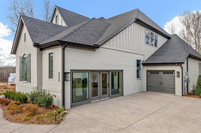 7247 Murrel Dr, Franklin, TN 37064 - view of front facade with brick siding, board and batten siding, a shingled roof, and a garage