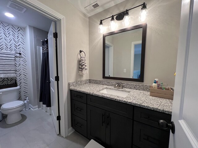 bathroom with visible vents, vanity, and toilet