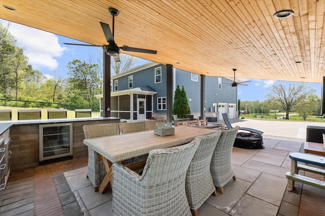 3181 Old Lebanon Dirt Rd, Mount Juliet, TN 37122 - view of patio with a bar, ceiling fan, outdoor dining space, a sunroom, and beverage cooler