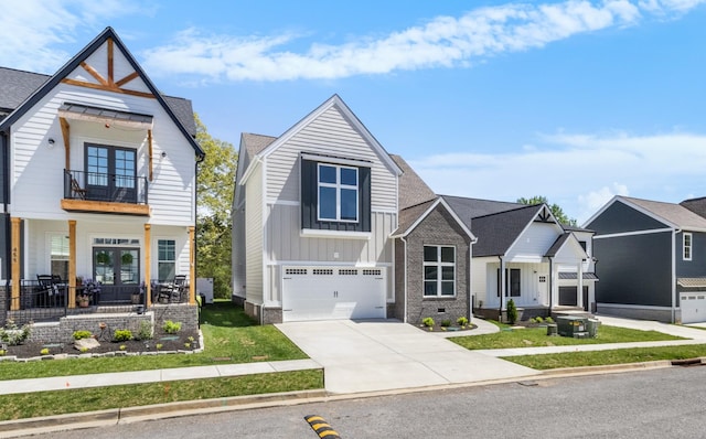 463 Centre St, Pleasant View, TN 37146 - view of front of house with french doors, driveway, a garage, a balcony, and board and batten siding