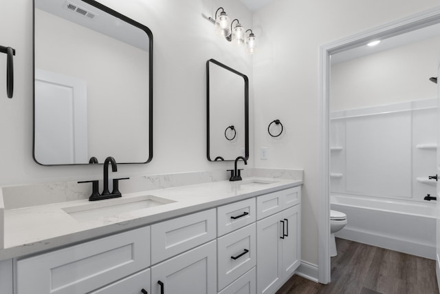 463 Centre St, Pleasant View, TN 37146 - full bath featuring wood finished floors, visible vents, toilet, and a sink