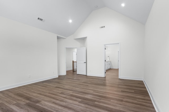 463 Centre St, Pleasant View, TN 37146 - unfurnished bedroom featuring baseboards, wood finished floors, visible vents, and high vaulted ceiling