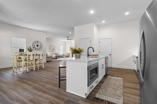 463 Centre St, Pleasant View, TN 37146 - kitchen featuring a kitchen bar, appliances with stainless steel finishes, a sink, and dark wood-type flooring