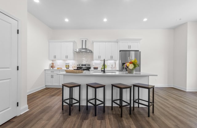 463 Centre St, Pleasant View, TN 37146 - kitchen with wall chimney range hood, a sink, a kitchen island with sink, appliances with stainless steel finishes, and dark wood-style floors