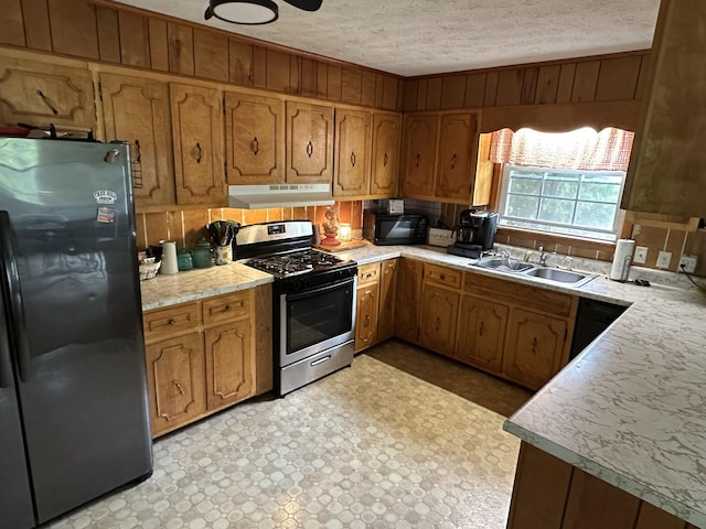 12748 Fruit Hill Red Bridge Rd, Crofton, KY 42217 - kitchen with light floors, under cabinet range hood, light countertops, black appliances, and a sink