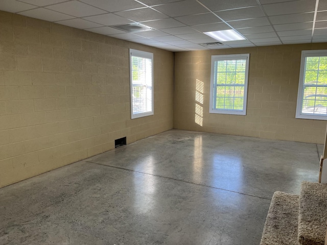 1473 Chapmansboro Rd, Chapmansboro, TN 37035 - spare room featuring a drop ceiling, concrete floors, and concrete block wall