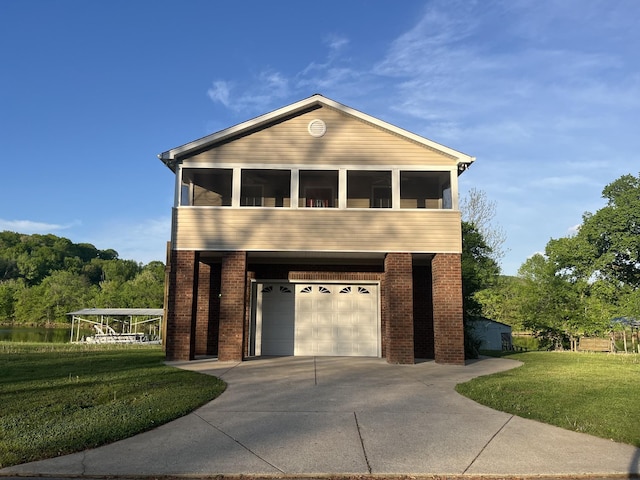 1473 Chapmansboro Rd, Chapmansboro, TN 37035 - view of front of home featuring a front yard, brick siding, driveway, and a garage